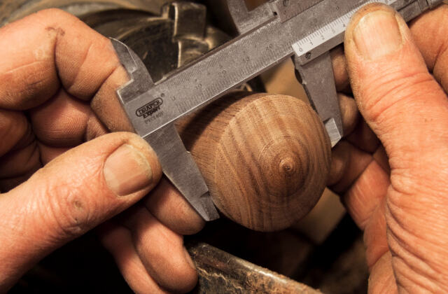 A tradesman measuring a workpiece